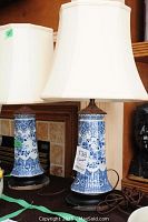 Pair of lamps displayed side by side, showing porcelain bodies, bases, cords, and shades