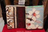 Front view of two tiles side by side showing ornate scroll design and magnolia flower design