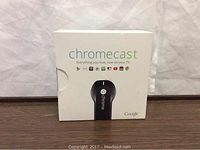 Front of the original retail box showing Chromecast device image and product name.