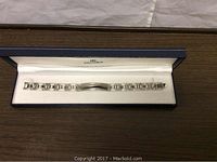Men's sterling silver Dolan-Bullock adjustable bracelet inside branded box, showing full length and polished finish.