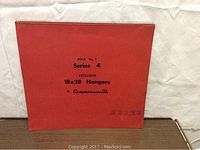 Front cover of 1957 salesman sample calendar with red cover labeled 'Book No.7 Series 4 Exclusive 18x28 Hangers By Commonwealth'.