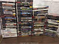 Front view of stacked game cases showing PS2, PSP, PS3, Wii titles