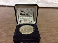 Medallion displayed in black velvet presentation case with certificate of authenticity numbered 05521.