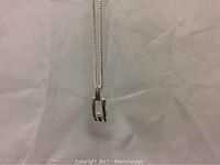 Front view of sterling silver pendant with diamond and part of the chain visible