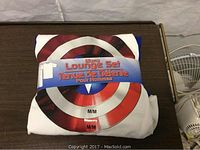 White Captain America short-sleeve top with shield graphic and packaging band indicating size medium.