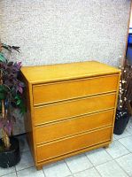 Full front view of the Kroehler tall boy dresser showing the four drawer fronts and wood finish.