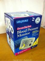 Box of the Life Source Deluxe One Step Blood Pressure Monitor UA-767 Plus, showing product name and highlights like lifetime warranty and memory storage.