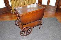 Overall view of wood tea cart with removable tray set on top