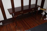 Full view of the wooden sofa table with dark polished finish, showing two drawers and cabriole legs.