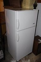 Full exterior view of the white Summit refrigerator with both freezer and fridge doors visible, showing the size and condition externally.
