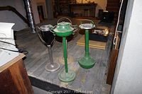 Four vintage standing ashtrays grouped together showing overall size and form.