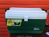 Front and top view of green and white Igloo cooler marked Legend 54 with wear on lid.