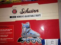 Box label showing Schwinn Breeze Women's Adjustable Skate name and features including moisture management liner, custom fit adjustability, power strap, locking buckle, ABEC-7 speed bearings, and 70mm wheels.