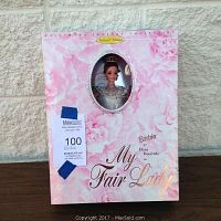 Front of unopened collector box showing Barbie doll face and floral box design.