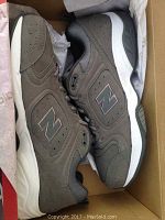 Pair of gray New Balance men's tennis shoes, size 13, unused and new in box, taken inside the shoebox.