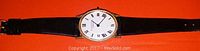 Front view of vintage R. Dupont ladies wristwatch showing round white dial with black Roman numerals and black leather band.