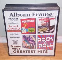 Photo showing 5 shrink-wrapped black bordered LP album frames stacked side by side with front cover showing album art samples and usage info