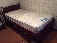 Overall view of twin bed frame with mattress in bedroom