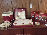 Full lot arranged on wooden surface showing napkin cylinder, plate boxes, serving utensils boxes, placemat box, and coasters