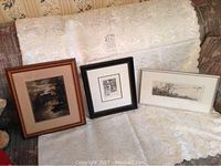 Three framed prints on lace covered couch showing overall lot contents