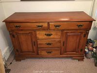 Full front view of solid maple buffet showing top surface, drawers, doors, and base.