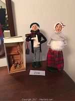 The two Byers Choice Ltd. figurines displayed side by side with a boxed carved wooden Nativity set.
