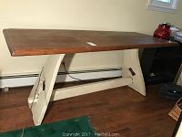 Full view of the rectangular solid wood harvest table showing natural wood top and white painted sturdy base with broad legs.