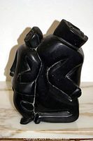 Side view of carving showing kneeling mother and child figures