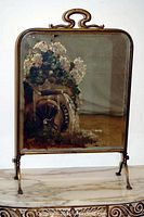 Full front view of the Victorian brass fire screen with bevelled mirror showing entire painted waterwheel and floral scene.