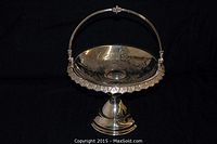 Full view of the antique quadruple silver-plated centerpiece basket with handle and scalloped edge.