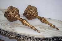 Both sconces displayed on marble surface, showing full pair and overall condition