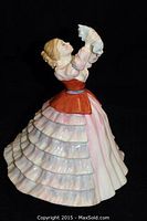 Oblique front view showing full figure and multi-tiered skirt detail