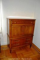 Full view of tall wooden highboy dresser against wall