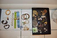 Tray with bangles, bracelets, cuff, two wristwatches on straps, earrings and rings