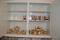 Shelving unit displaying all porcelain tea and coffee sets