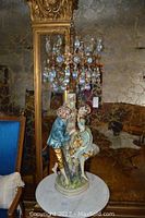 Full view of porcelain figural lamp on marble table