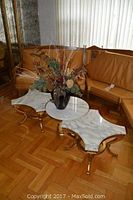 All three marble tables arranged with decorative vase on top
