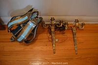 Overview of hanging lamp and two wall sconces on hardwood floor