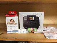 Canon Selphy CP800 printer box alongside Canon 4x6 inch paper and ink set box, with auction lot tag visible.