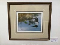 Full view of framed and matted paper tole loon artwork hanging on a wall, showing the entire piece measuring approximately 18x16 inches.