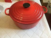 Exterior view of red round Dutch oven with lid in place