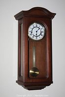 Full view of Montreux wooden wall pendulum clock with glass front door and brass pendulum.