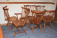 Full set of six Bassett maple dining chairs on blue carpet in room corner