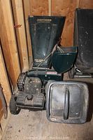 Full view of Craftsman wood chipper shredder showing green and black body, wheels, and feeding chute.