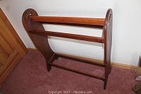 Full view of wooden blanket rack showing overall design and structure.