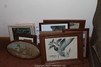 Grouped artwork mainly animal and wildlife hunting and fishing themed, framed, various sizes.