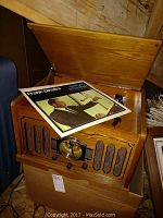 Wooden Museum Thomas Series phonograph with the lid open, showing a Frank Sinatra vinyl record on top.