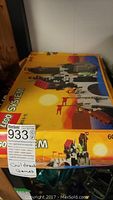 Photo showing original Lego System model 6075 set box with colorful space-themed vehicle artwork and trademarks.