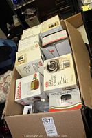 Box containing multiple boxed new coffee carafes and some coffee accessories like paper coffee filters.