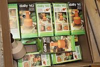 Box of 7 Daily 142 food choppers in their original packaging showing the orange and beige cylindrical choppers.